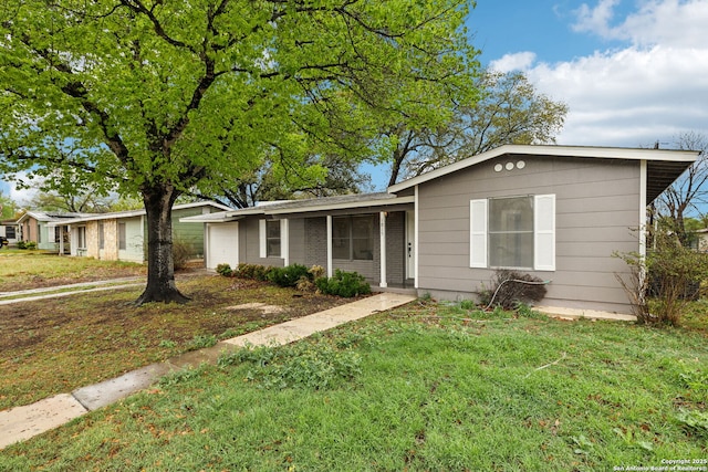 view of front of home featuring an attached garage and a front lawn