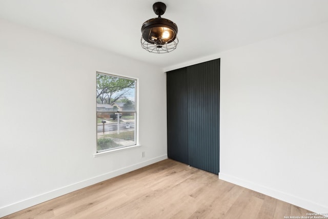 unfurnished bedroom with baseboards and light wood-style floors