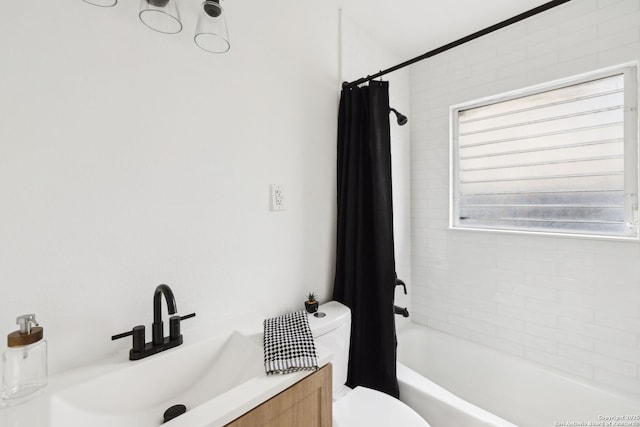 full bath featuring shower / bath combination with curtain, toilet, and a sink