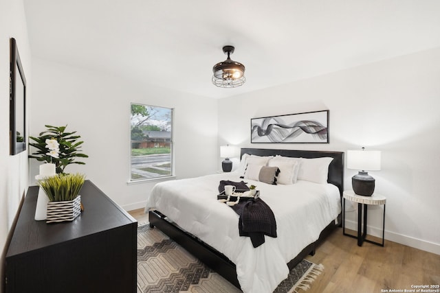 bedroom with baseboards and light wood-style flooring