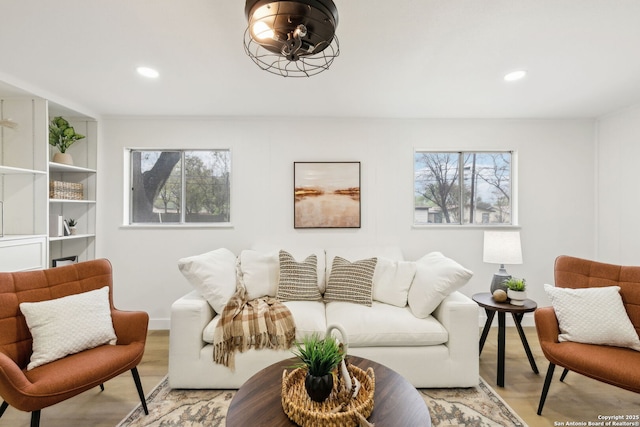 living room with baseboards, light wood-style floors, and recessed lighting