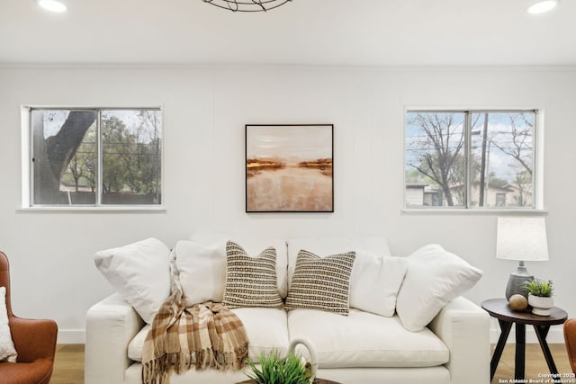 living room featuring recessed lighting, ornamental molding, baseboards, and wood finished floors