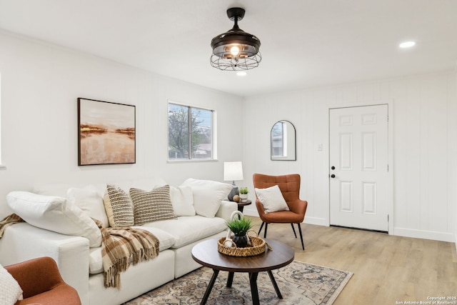 living area featuring baseboards, recessed lighting, and light wood-type flooring