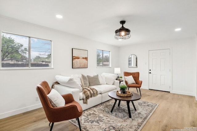 living area featuring light wood-style flooring, baseboards, and recessed lighting