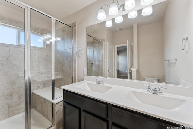2297 Olive Hl, New Braunfels, TX 78130 - bathroom with toilet, a sink, a shower stall, and visible vents