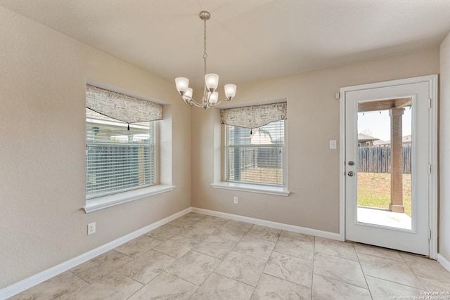 2297 Olive Hl, New Braunfels, TX 78130 - unfurnished dining area with an inviting chandelier, baseboards, and a wealth of natural light