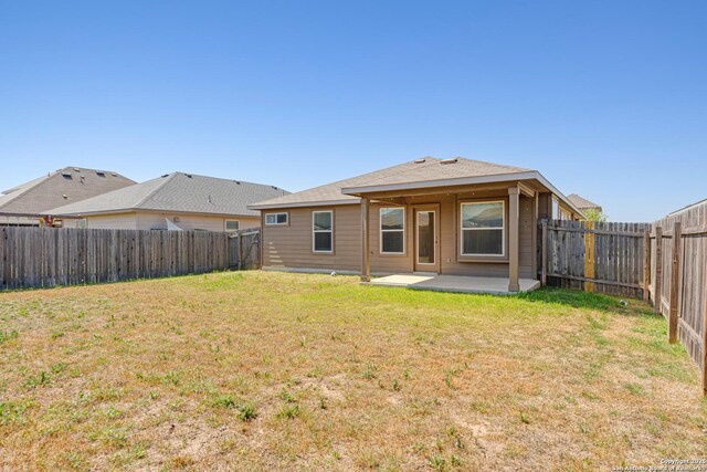 2297 Olive Hl, New Braunfels, TX 78130 - rear view of property with a fenced backyard, a lawn, and a patio