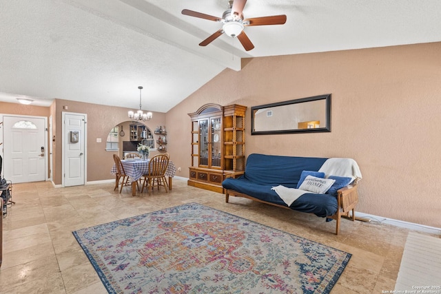 living room with lofted ceiling with beams, ceiling fan with notable chandelier, baseboards, a textured ceiling, and light tile patterned flooring
