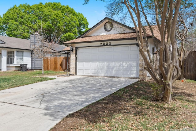ranch-style home with a garage, fence, concrete driveway, and roof with shingles