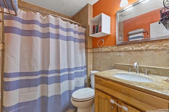 full bath with tile walls, a textured ceiling, a shower with shower curtain, toilet, and vanity