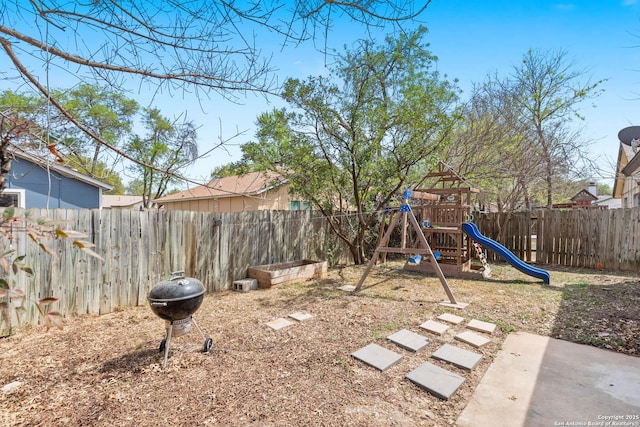 view of yard featuring a fenced backyard and a playground