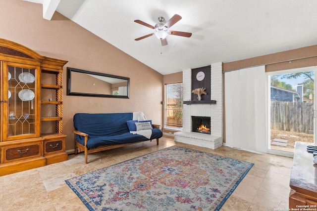 tiled living room featuring vaulted ceiling, a ceiling fan, and a brick fireplace