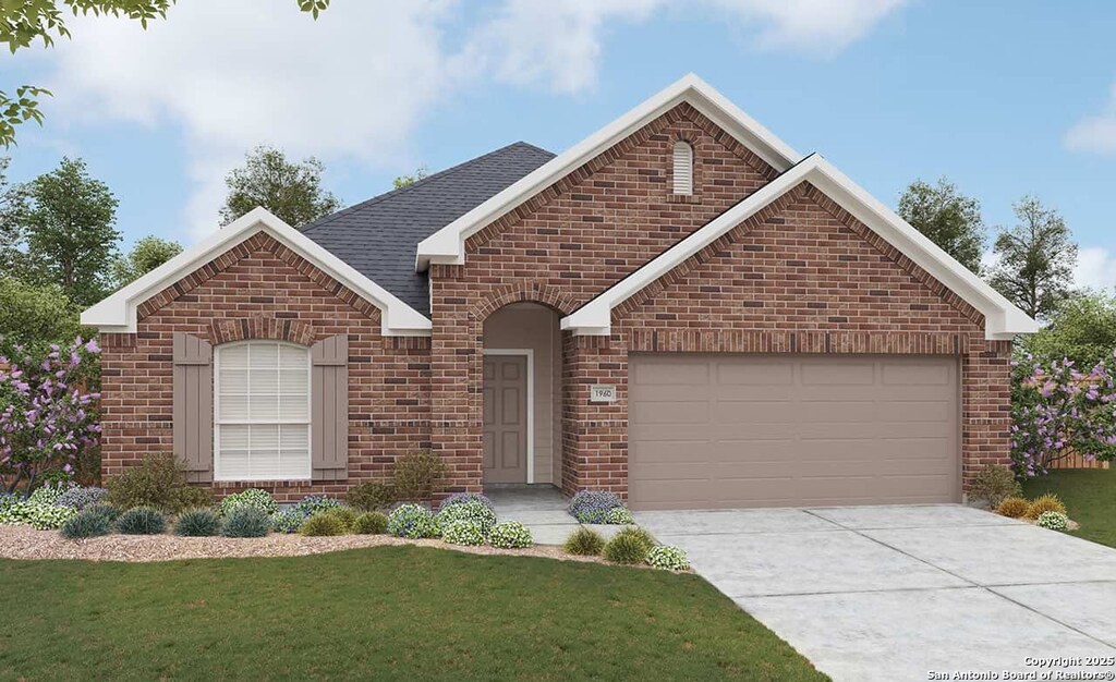 view of front facade with driveway, a front yard, an attached garage, and brick siding