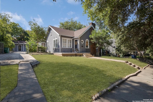 view of front facade with a front lawn and a chimney
