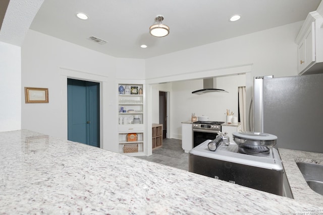kitchen with white cabinetry, appliances with stainless steel finishes, wall chimney range hood, visible vents, and recessed lighting