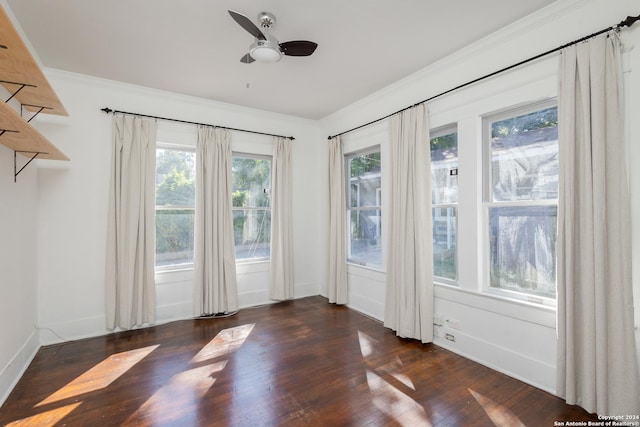 unfurnished room featuring baseboards, crown molding, wood finished floors, and ceiling fan