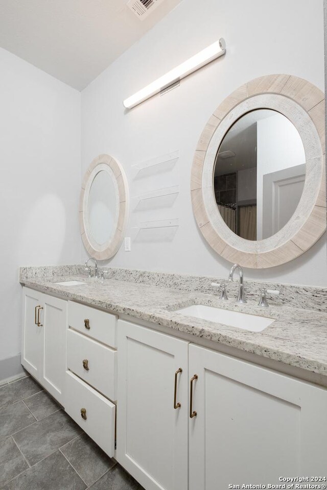 full bath featuring double vanity and a sink