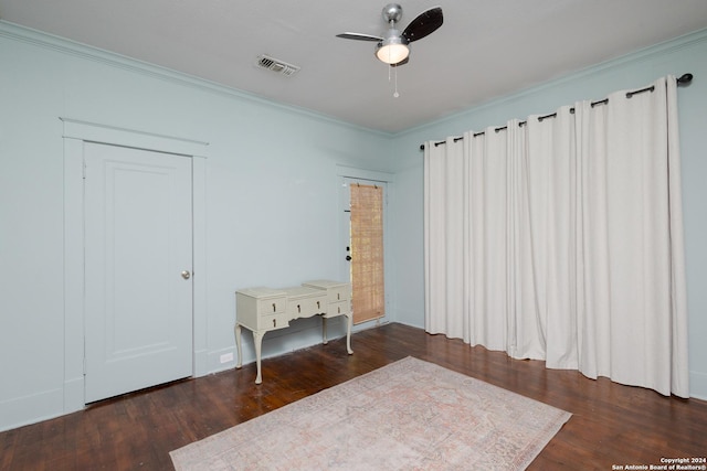 unfurnished bedroom featuring a ceiling fan, visible vents, crown molding, and wood finished floors