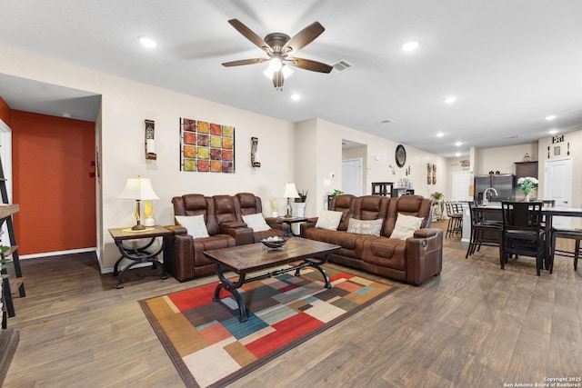 living room featuring visible vents, recessed lighting, a ceiling fan, and wood finished floors
