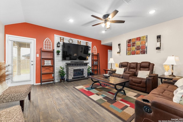 living area featuring a fireplace, wood finished floors, recessed lighting, a ceiling fan, and lofted ceiling