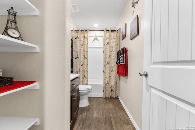 bathroom with toilet, vanity, shower / bath combo, wood finished floors, and baseboards