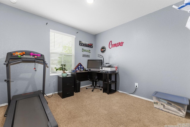 carpeted office featuring baseboards