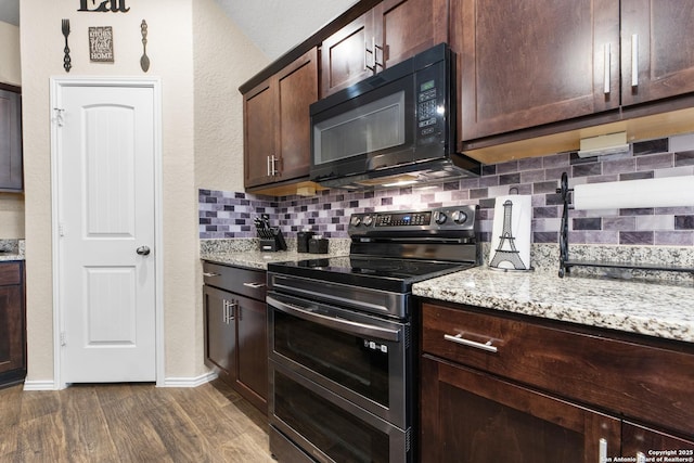 kitchen featuring double oven range, tasteful backsplash, dark wood-style flooring, dark brown cabinets, and black microwave