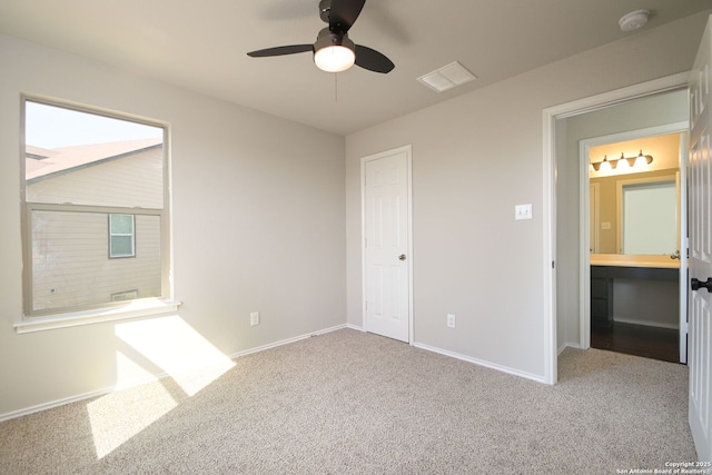 unfurnished bedroom featuring carpet flooring, baseboards, and visible vents