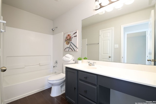 full bathroom featuring washtub / shower combination, wood finished floors, toilet, and vanity