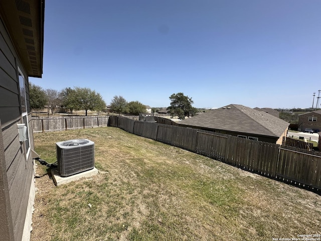 view of yard with cooling unit and a fenced backyard