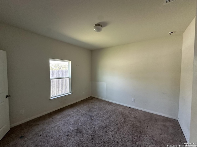 carpeted empty room with baseboards
