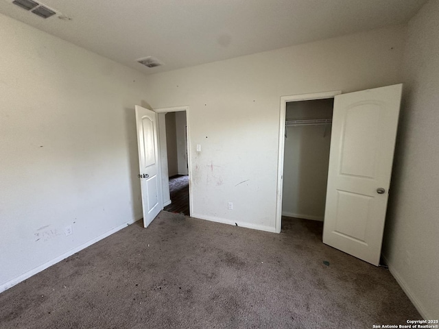 unfurnished bedroom with carpet flooring, baseboards, a closet, and visible vents