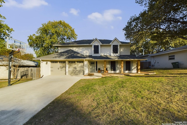traditional-style home featuring driveway, an attached garage, fence, and a front lawn