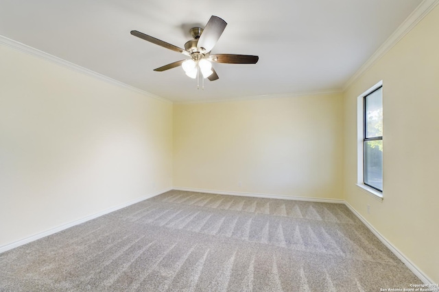 unfurnished room featuring light carpet, baseboards, crown molding, and a ceiling fan