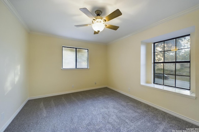 unfurnished room featuring ornamental molding, baseboards, dark carpet, and ceiling fan