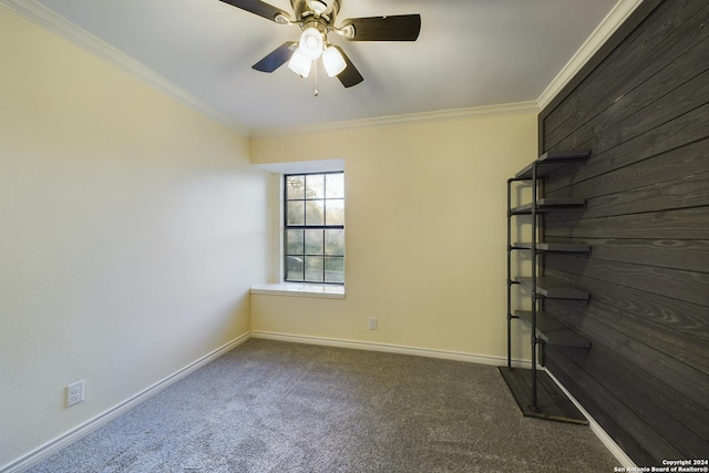 carpeted empty room featuring baseboards, crown molding, and a ceiling fan