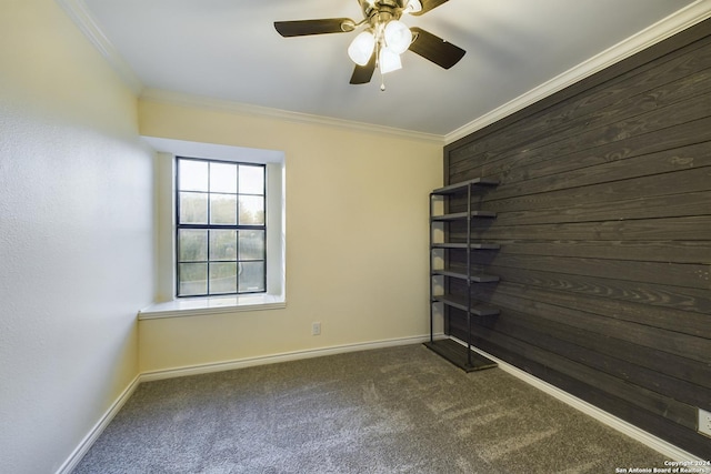 spare room with baseboards, carpet floors, ceiling fan, and crown molding