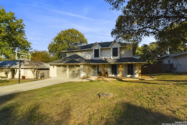 traditional-style home with a front lawn, fence, driveway, and an attached garage