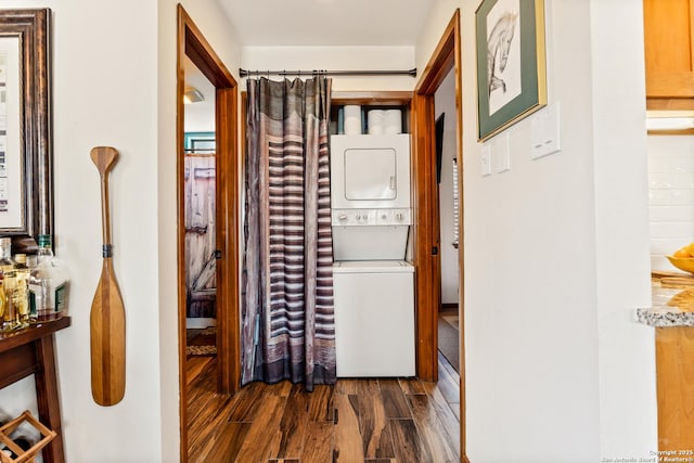 hallway featuring dark wood-style flooring and stacked washing maching and dryer