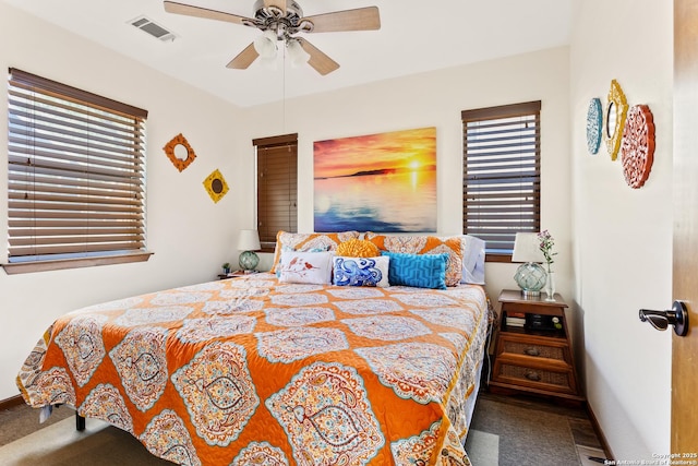 bedroom with carpet flooring, multiple windows, ceiling fan, and visible vents