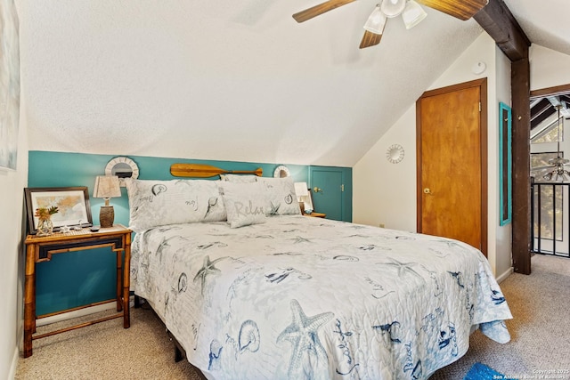 bedroom with lofted ceiling with beams, ceiling fan, and carpet floors