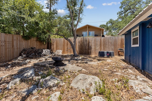 view of yard featuring an outdoor fire pit and a fenced backyard