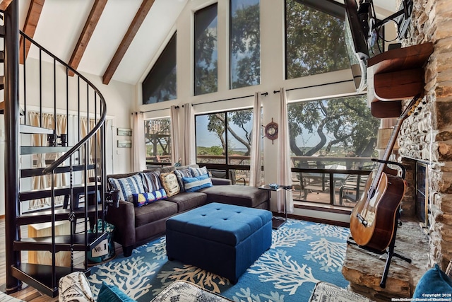 living room featuring beam ceiling, high vaulted ceiling, stairs, and wood finished floors