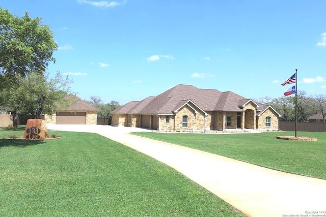 single story home featuring fence, concrete driveway, a front lawn, and stone siding