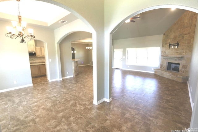 unfurnished living room featuring baseboards, visible vents, a fireplace, and a notable chandelier