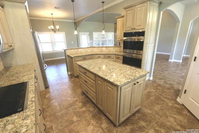 kitchen with arched walkways, baseboards, appliances with stainless steel finishes, and a peninsula