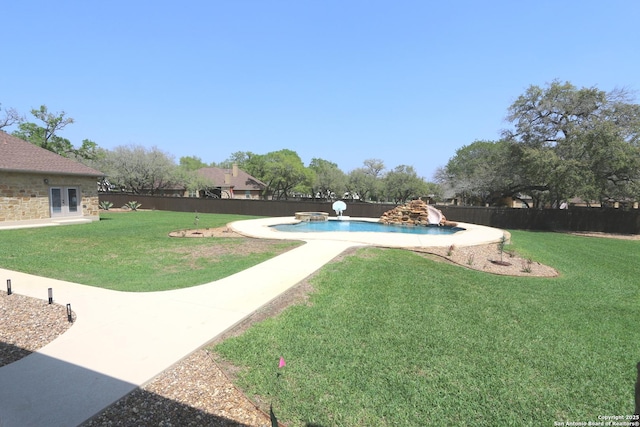 view of yard with french doors, a fenced in pool, and a fenced backyard