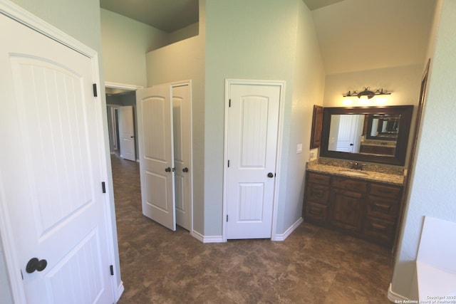interior space with vanity and vaulted ceiling