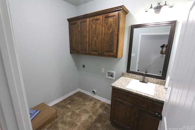 clothes washing area featuring baseboards, hookup for a washing machine, a sink, cabinet space, and hookup for an electric dryer