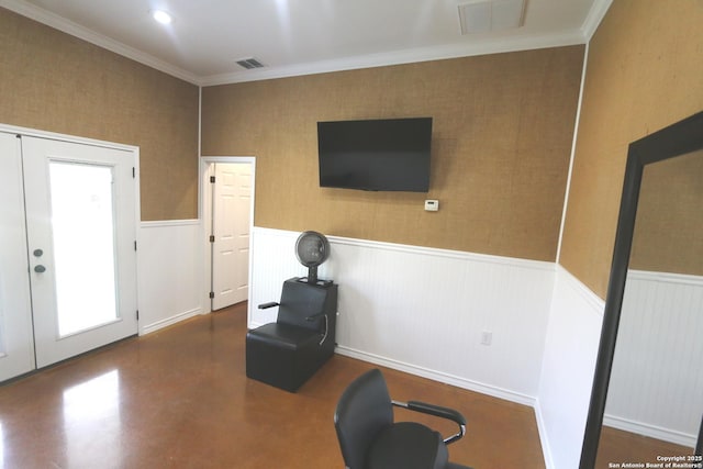 workout room featuring crown molding, visible vents, and a wainscoted wall